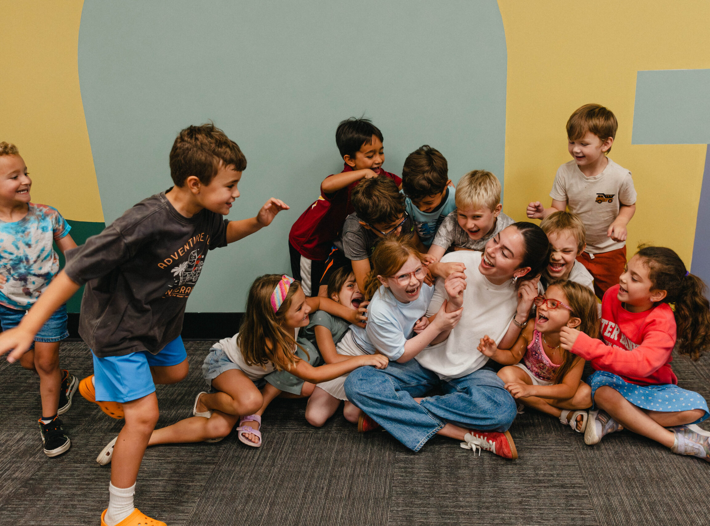 Child running with football during camp sports